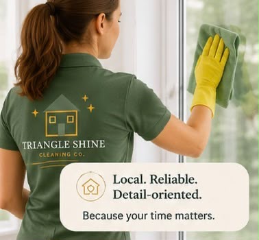 Triangle Shine cleaning professional wiping a window.